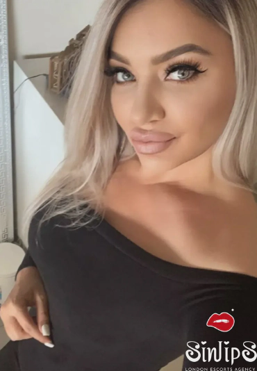 Debbie, blonde escort in London, selfie in a black top